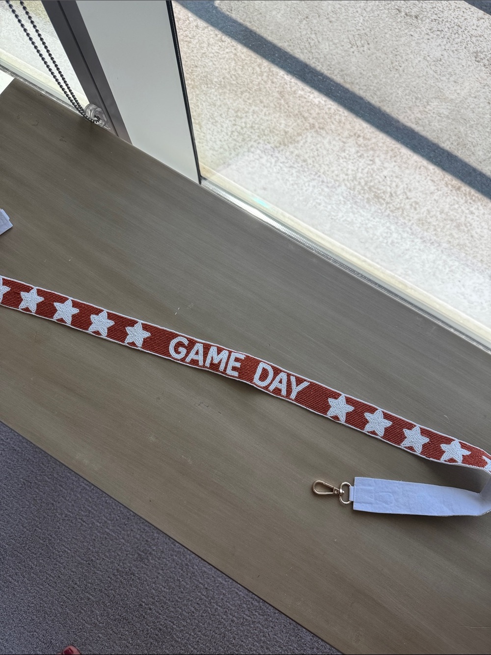 Burnt orange beaded game day bag strap